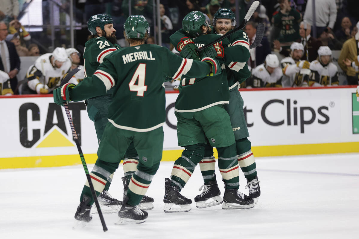 Minnesota Wild right wing Ryan Hartman, right, celebrates with teammates after scoring during t ...
