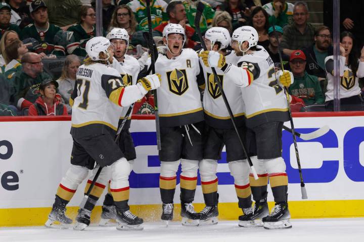Vegas Golden Knights center Jack Eichel, center, celebrates with teammates after scoring during ...