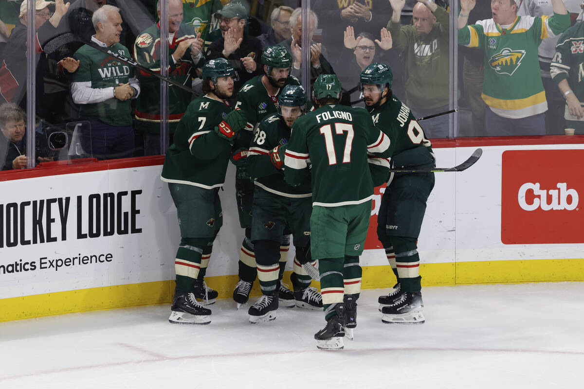 Minnesota Wild right wing Ryan Hartman (38) celebrates with teammates after scoring during the ...