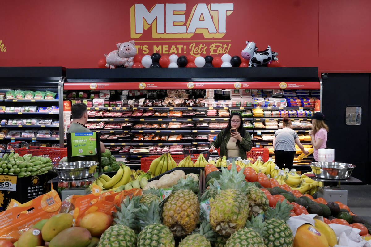 Shoppers check out meat and produce during the grand opening of a new Grocery Outlet at 9320 S. ...