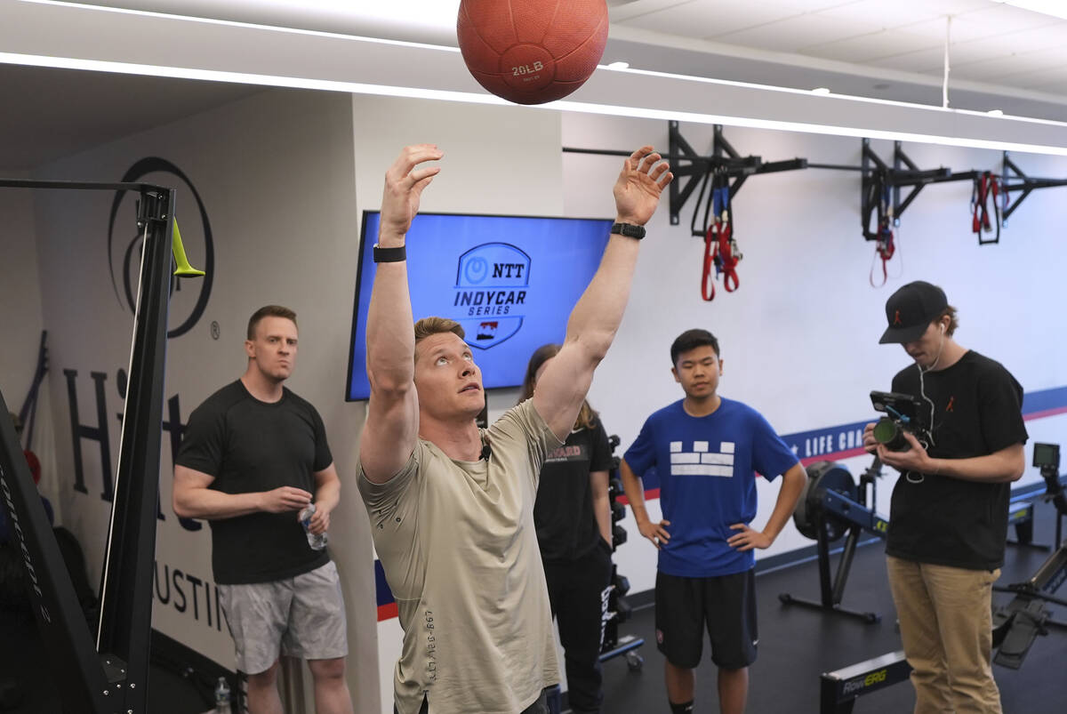 Two-time IndyCar series champion Josef Newgarden, center, leads a group through the paces of hi ...