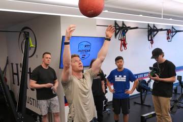 Two-time IndyCar series champion Josef Newgarden, center, leads a group through the paces of hi ...