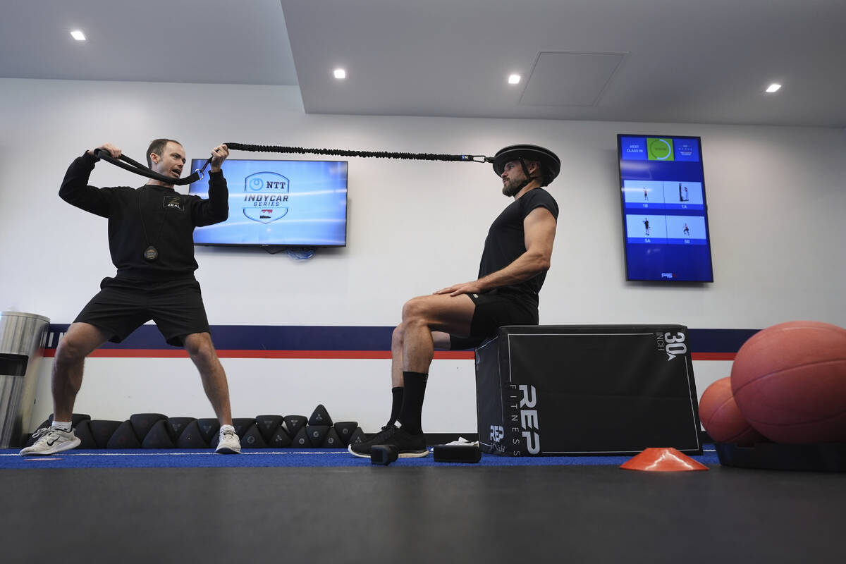 Jeff Richter, trainer for IndyCar series champion Josef Newgarden, works with Austin Nichols, r ...