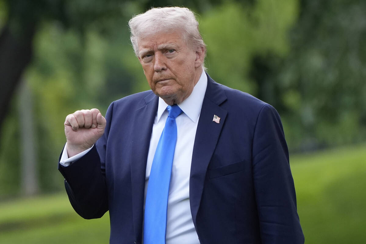 President Donald Trump gestures as he walks from the Oval Office to depart on Marine One from t ...