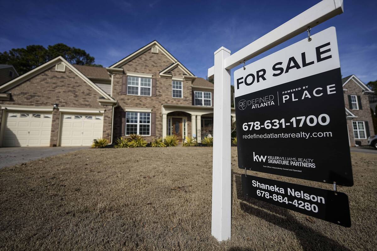 A sign announcing a home for sale is posted outside a home, Thursday, Feb. 1, 2024, in Aceworth ...