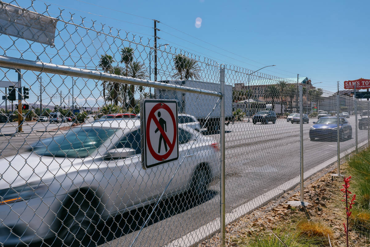 Traffic passes by a newly-erected fence on the median along the stretch of Boulder Highway, bet ...
