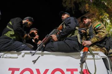 Syria's security forces stand on their vehicle, after reaching a deal with Druze gunmen to depl ...