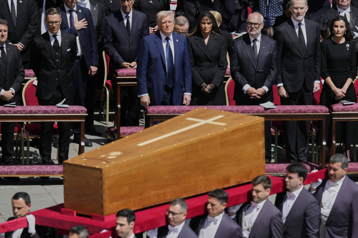 The coffin of Pope Francis is carried in front of dignitaries, including President Donald Trump ...