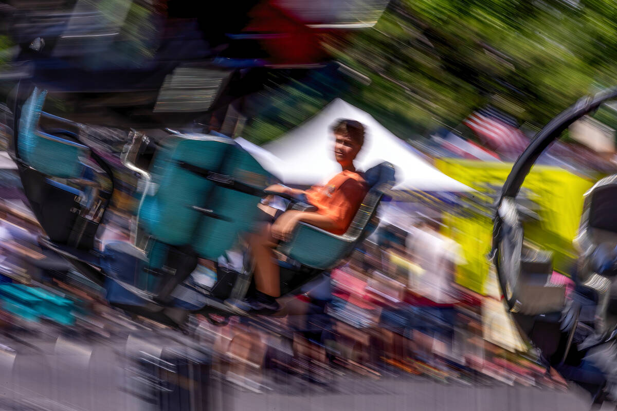 Kash Pinney, 9, of Boulder City takes a spin on the Tornado ride during the Spring Jamboree out ...