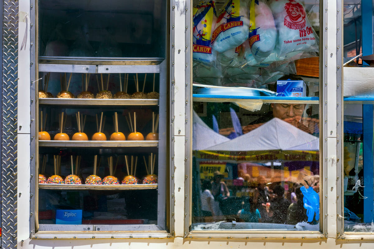 A vendor prepares to made more cotton candy during the Spring Jamboree outdoor festival in Bice ...