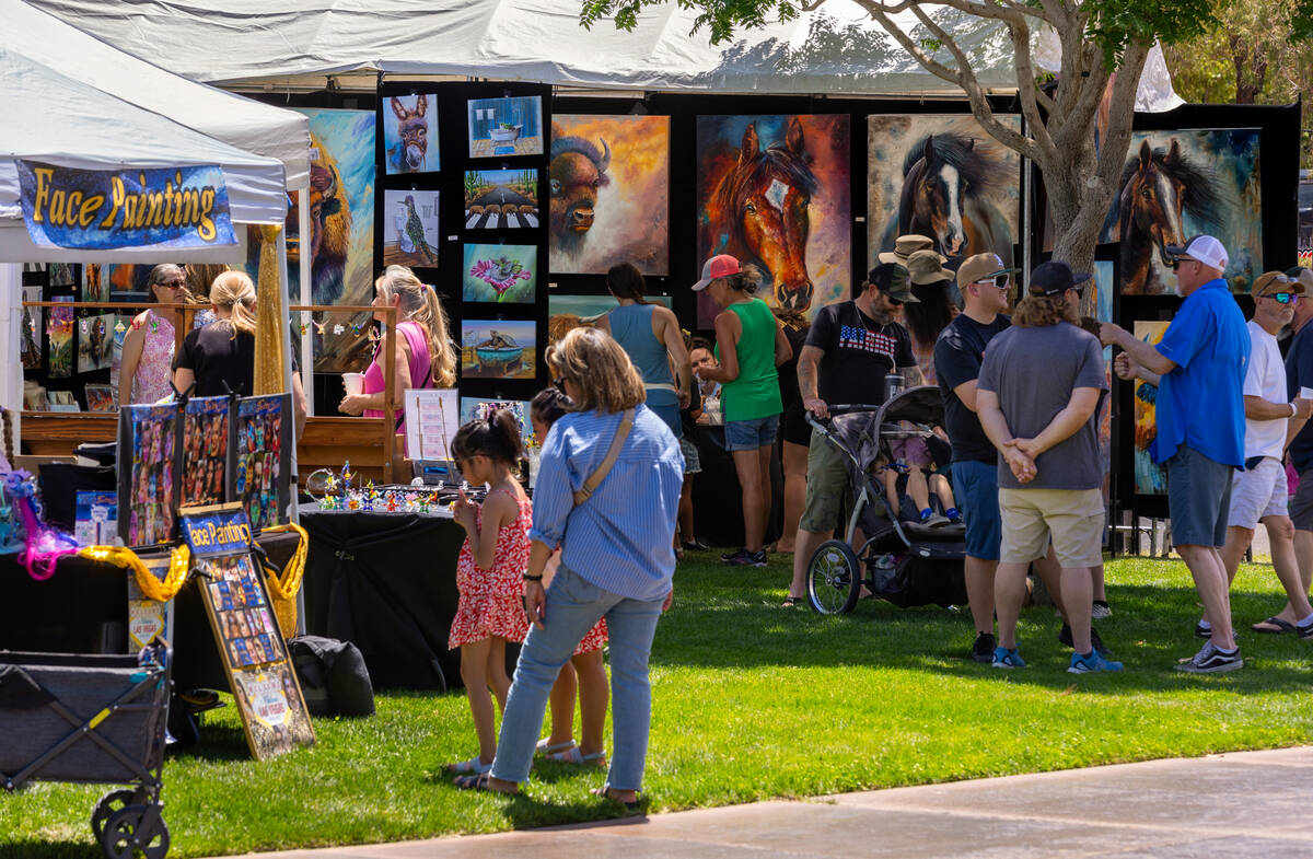 People take in the art and entertainment during the Spring Jamboree outdoor festival in Bicente ...