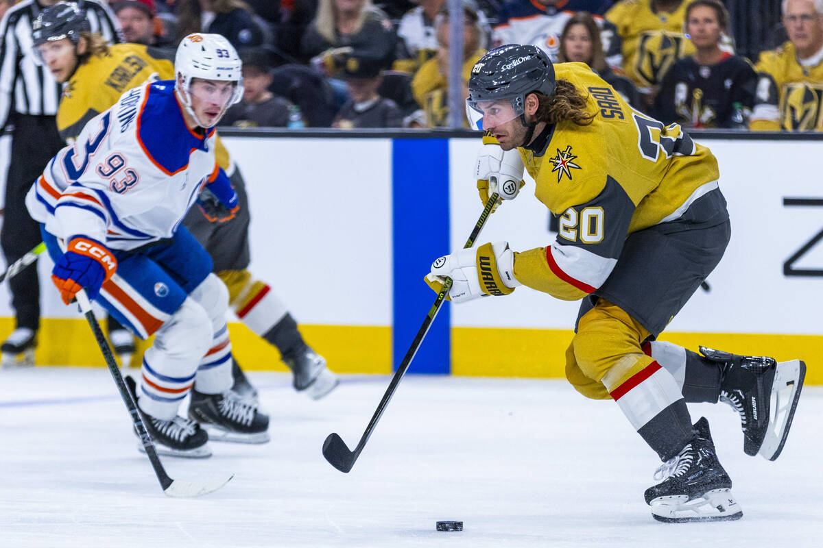 Golden Knights left wing Brandon Saad (20) advances the puck as Edmonton Oilers center Ryan Nug ...