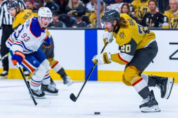 Golden Knights left wing Brandon Saad (20) advances the puck as Edmonton Oilers center Ryan Nug ...