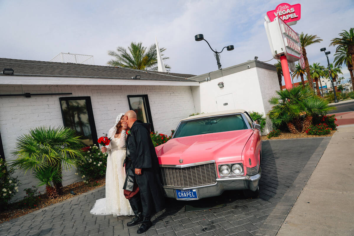 Celeste McCormack, left, kisses her groom, William, following a “Star Wars” theme ...