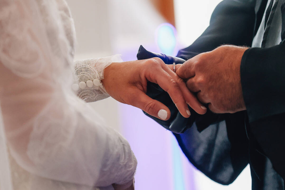 Brian McCormack puts a ring on the finger of his bride, Celeste, during a “Star Wars&#x2 ...