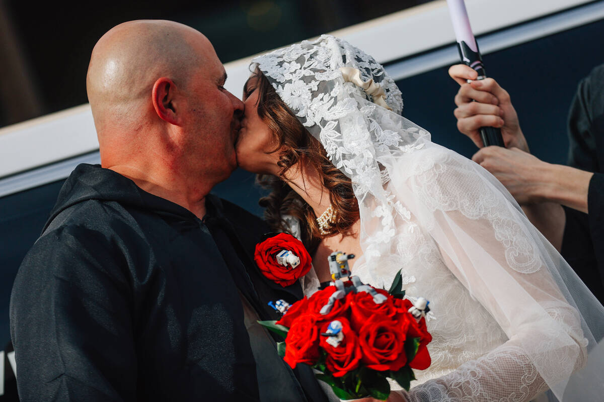 William McCormack, left, kisses his bride, Celeste, following their “Star Wars” t ...