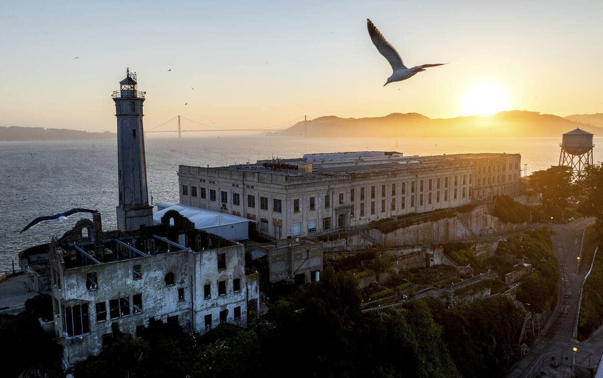 A bird flies above Alcatraz Island on Sunday, May 4, 2025, in the San Francisco Bay, Calif. (AP ...