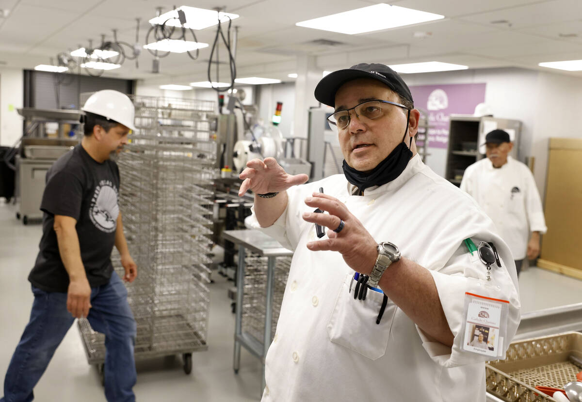Gene Benzel, director of culinary operations at Catholic Charities, describes the process durin ...