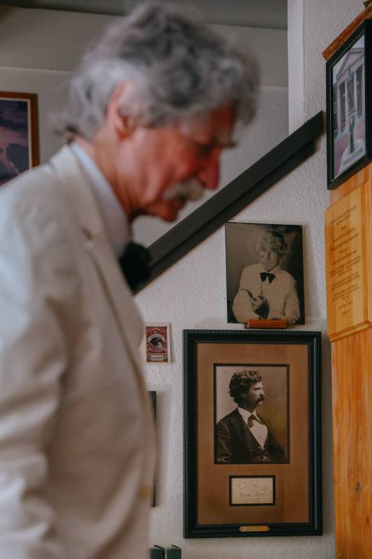 McAvoy Layne passes by a portrait of Mark Twain, bottom, framed with the author’s signature o ...