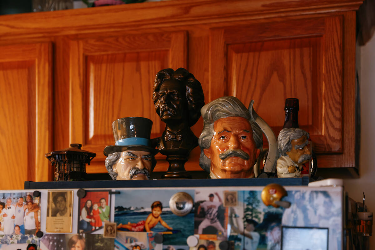 Mark Twain mugs sit atop McAvoy Layne’s refrigerator, which is covered in family photos and M ...