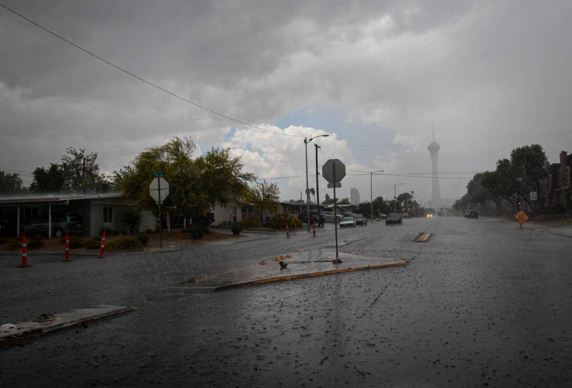 Small rocks and debris cover St. Louis Avenue at 15th Street as rain pours down Tuesday, May 6, ...