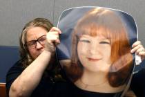 Tiffany Reynolds holds a photograph of her daughter McKenzie Scott as she attends a hearing for ...