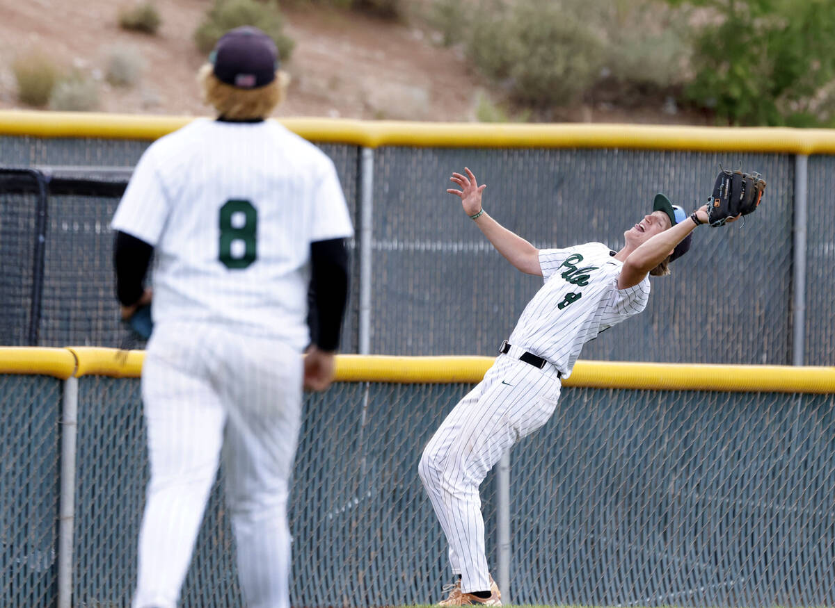 Palo Verde's Kyle Johnson catches a foul ball as pitcher Zach Franke, left, looks on during the ...