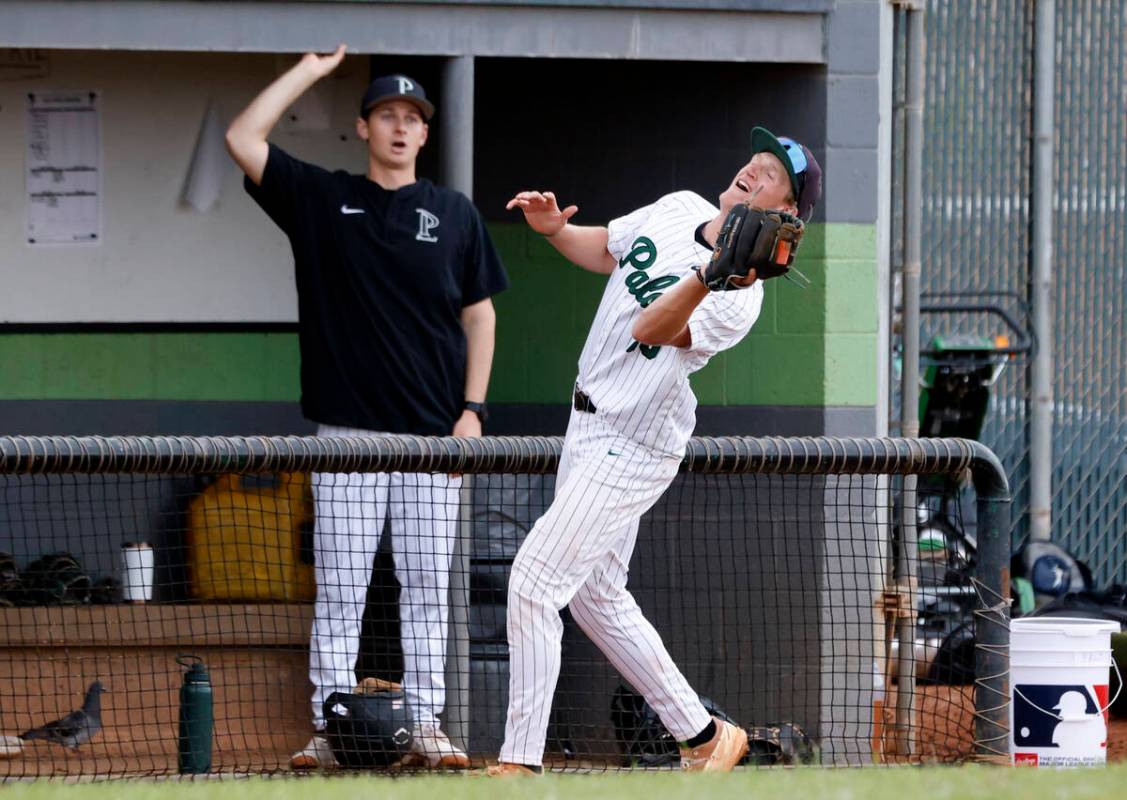 Palo Verde's Kyle Johnson catches a foul ball as coach Jeff Gerlica, left, looks on during the ...