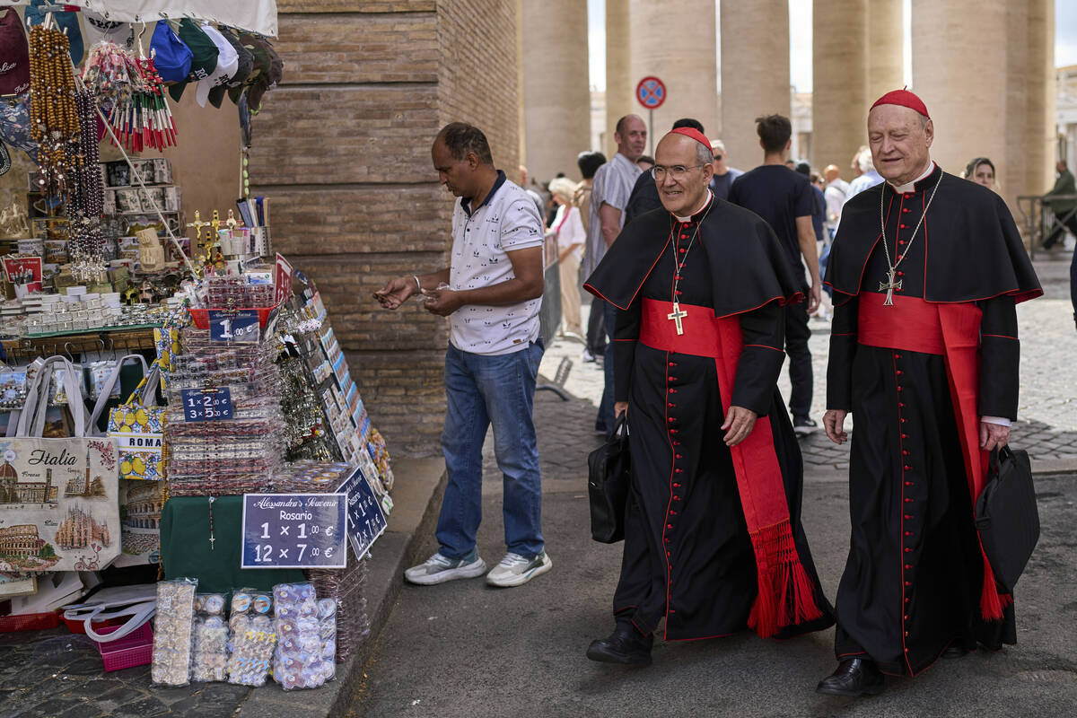 Cardinal José Tolentino de Mendonça, left, walks with Cardinal Gianfranco Ravasi at t ...