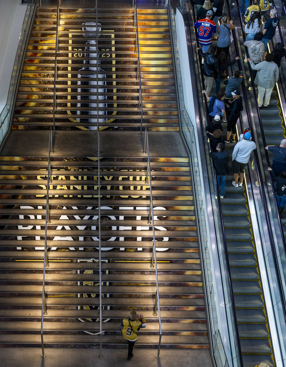 A fan walks up the decorated stairs just inside the arena before first period of game one in th ...