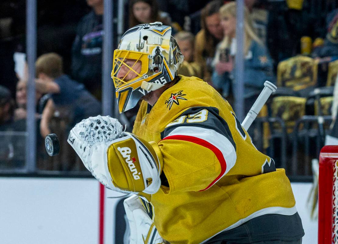 Golden Knights goaltender Adin Hill (33) deflects away a puck during the warm ups before first ...