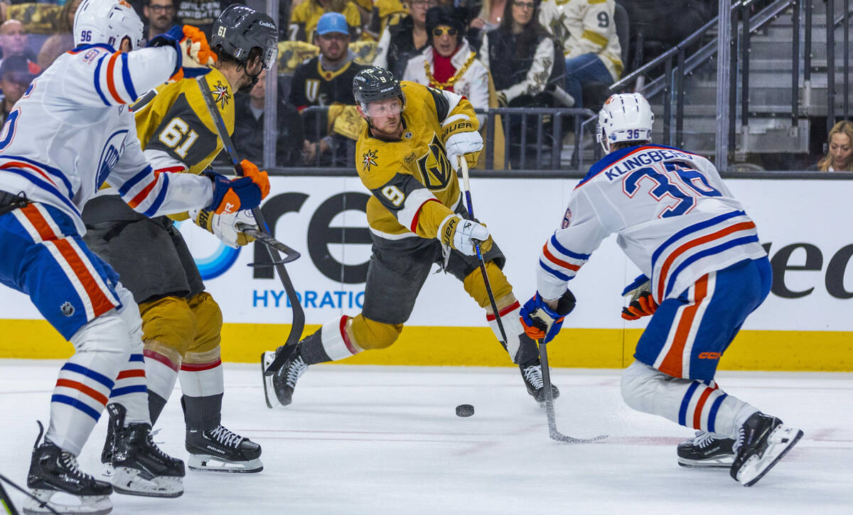 Golden Knights center Jack Eichel (9) takes a shot on goal with Edmonton Oilers defenseman John ...