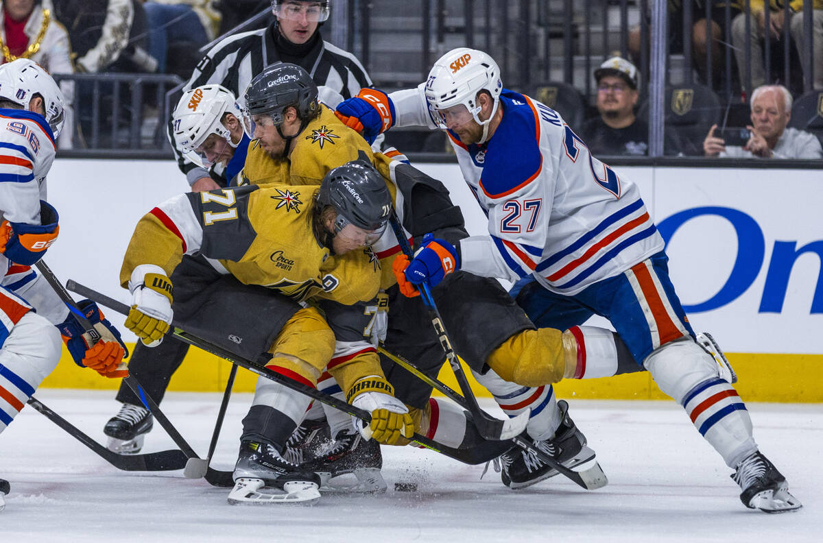 Golden Knights center William Karlsson (71) gets the face off but is crushed by a push from Edm ...