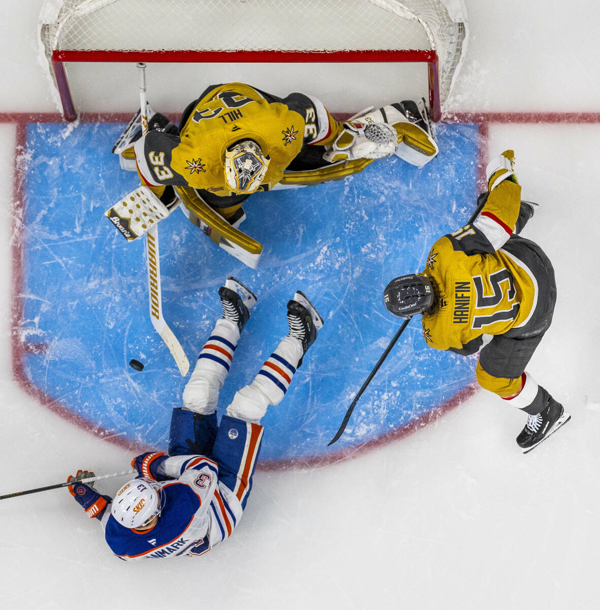 Golden Knights goaltender Adin Hill (33) rejects a shot by Edmonton Oilers center Mattias Janma ...