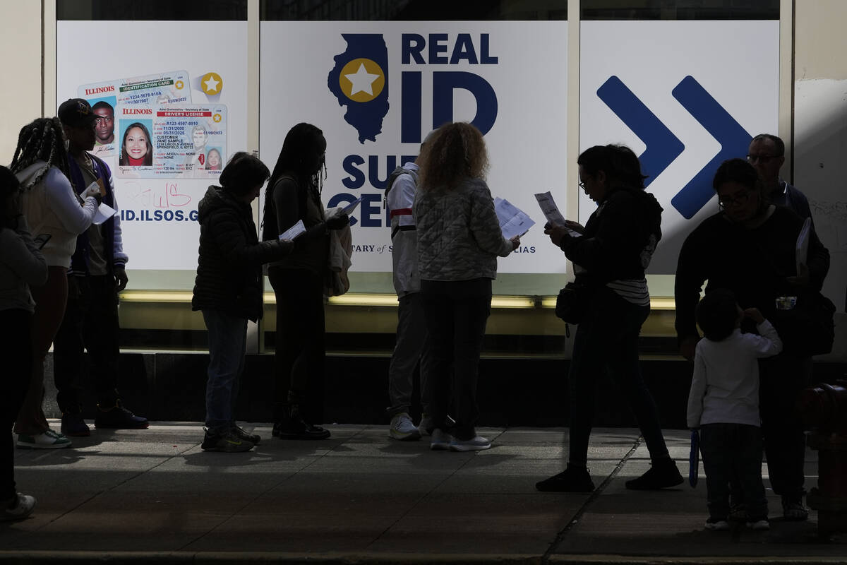 People line up to apply for Real ID at a Real ID Supercenter in downtown Chicago, Tuesday, May ...