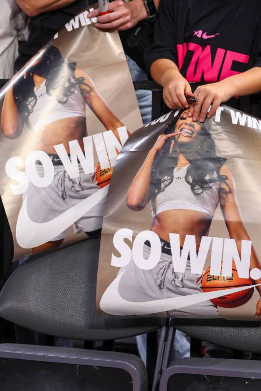 Fans hold Nike posters depicting Aces center A’ja Wilson, hoping to get them signed by p ...