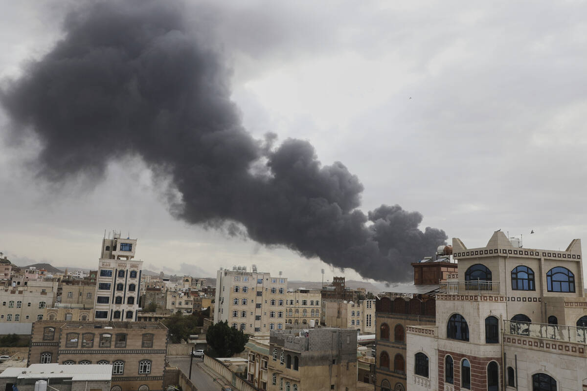 Smoke billows following Israeli airstrikes targeting a power plant and Sanaa Airport, in Sanaa, ...