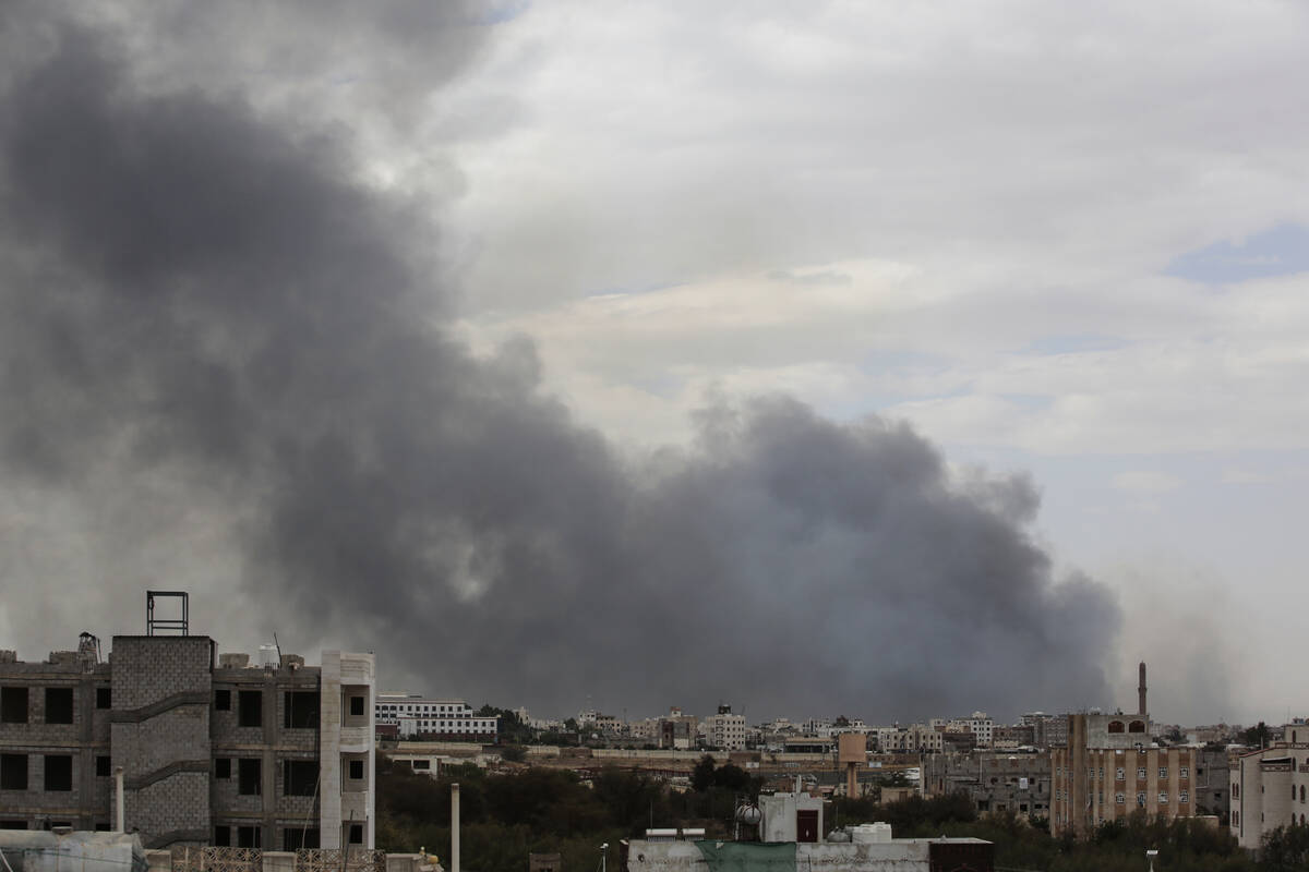 Smoke billows following Israeli airstrikes targeting a power plant and Sanaa Airport, in Sanaa, ...