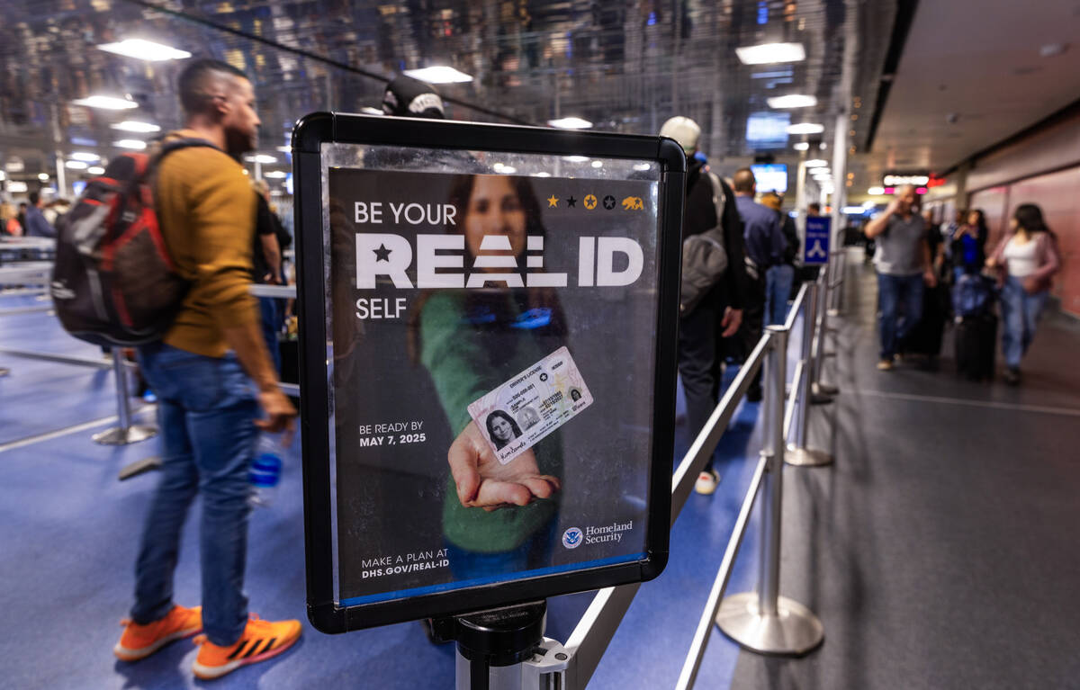 Travelers make their way to a TSA security checkpoint in Terminal One as the Real ID act is bei ...