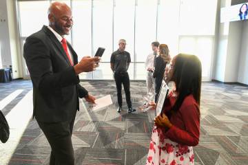 Sherjuan Brown takes a photo of his daughter Auzja Brown after she received her award during th ...
