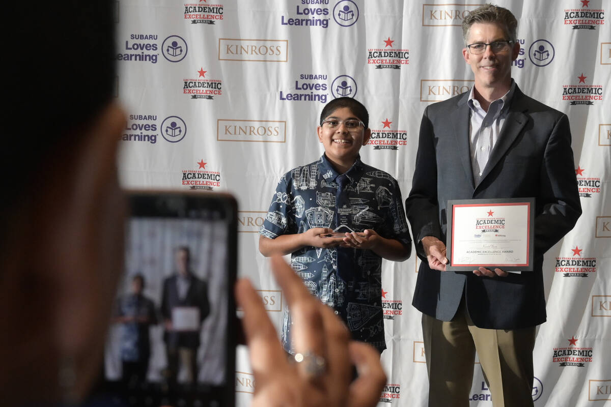 Seventh grade award winner Kaavel Basu has his photo taken with Las Vegas Review-Journal Execut ...