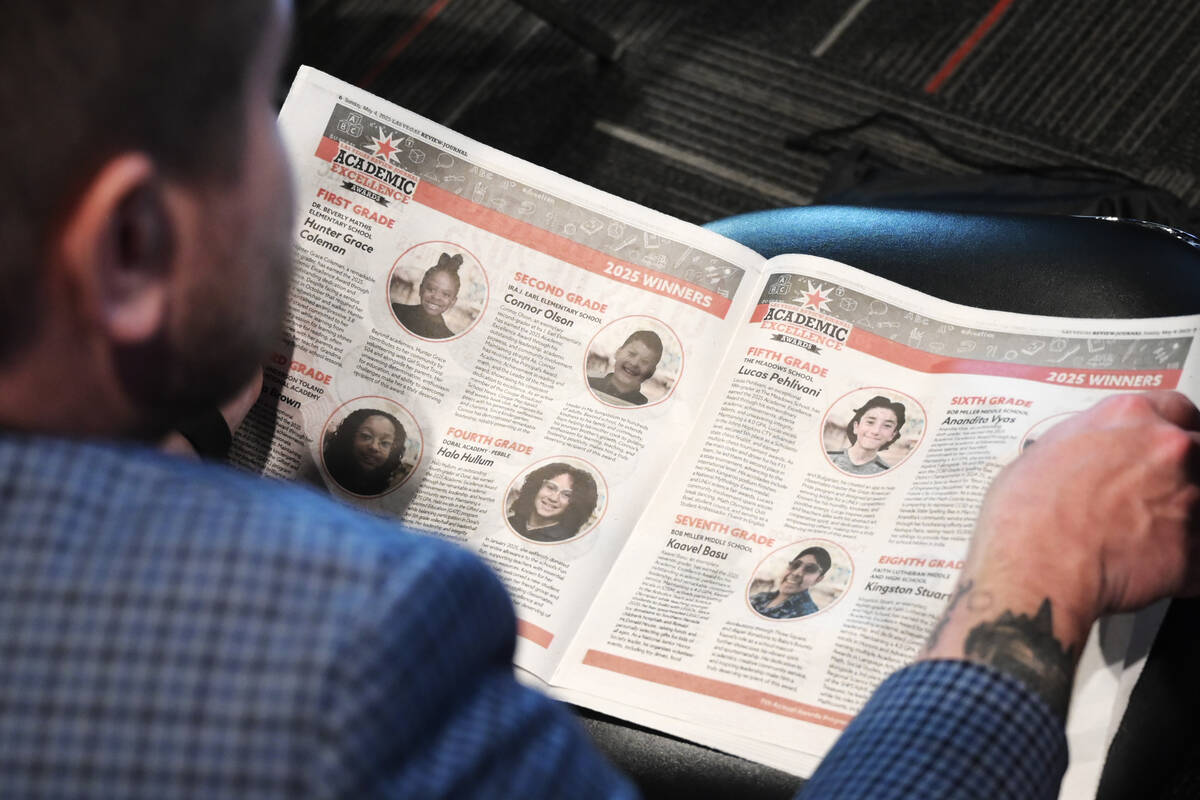 An attendee looks through a program during the Las Vegas Review-Journal’s Academic Excellence ...