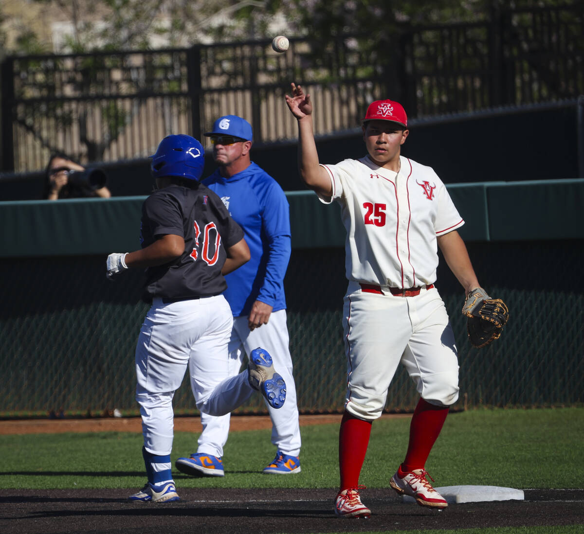 Arbor View's J Alex Scaggs (25) passes the ball after getting out Bishop Gorman's Koa Young (30 ...