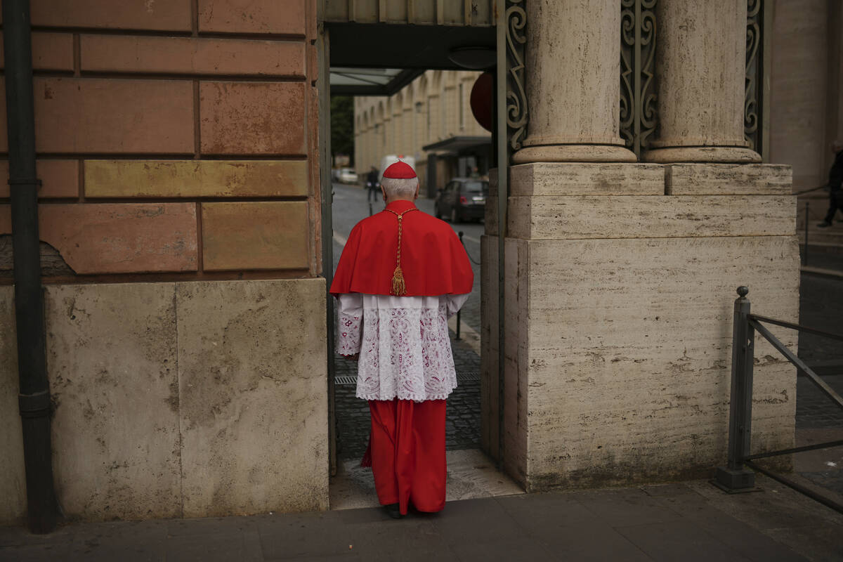 Cardinal Giuseppe Versaldi walks through the St. Anna gate, at the Vatican, Wednesday, May 7, 2 ...