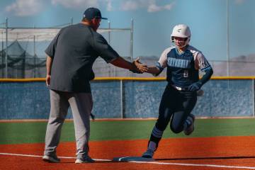 Centennial’s Sloane Merrell (8) high fives her coach as she rounds third base after hitt ...
