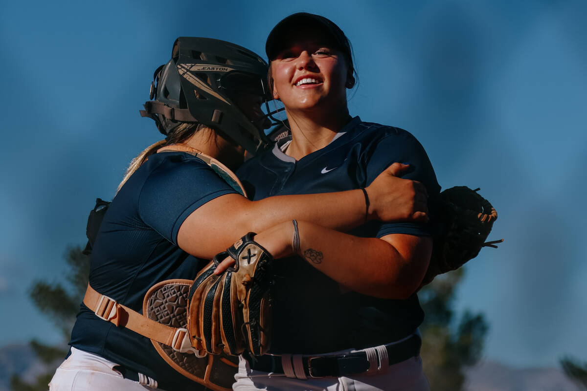 Shadow Ridge catcher Jacobi Gledhill (13) embraces teammate Madison Foster (18) after Foster su ...
