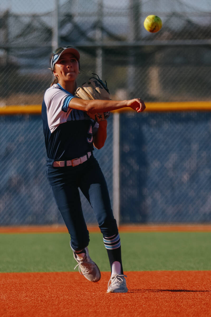 Centennial infielder Valeria Lopez (5) tosses the ball to first to attempt a putout during the ...