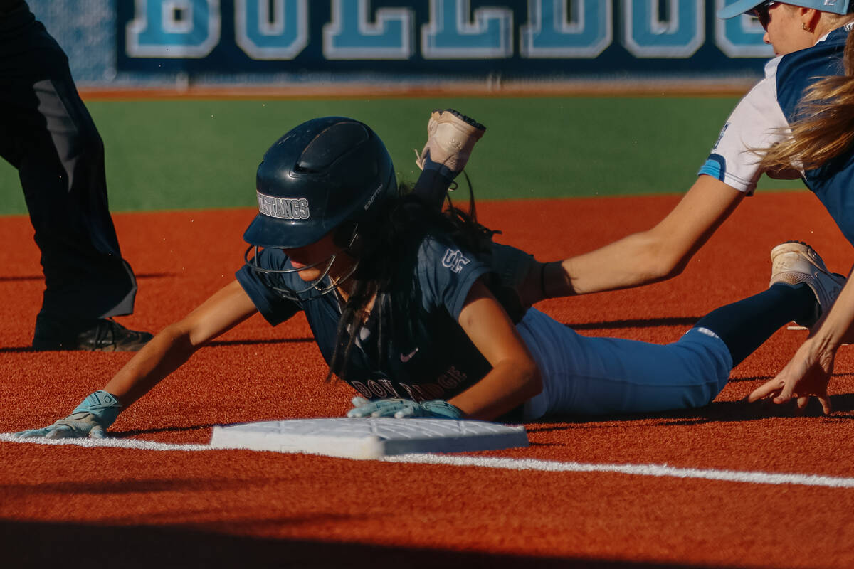 Shadow Ridge runner Melia Aionaaka (1) slides safely into third base, tagged too late by Centen ...