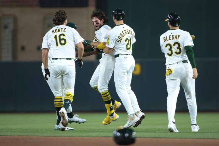 The Athletics celebrate their walkoff victory against the Seattle Mariners during the 11th inni ...