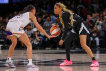 Aces guard Harmoni Turner (14) looks for a way around Phoenix Mercury guard Megan McConnell (16 ...